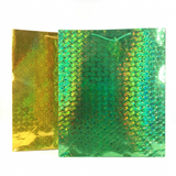 Two metallic gold and green patterned sheets on a white background