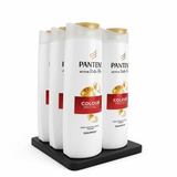 Four bottles of Pantene Colour Protect shampoo on a black stand with a white background