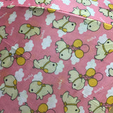 Pattern of cartoon dogs with balloons on a pink background