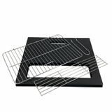 Black grill pan with metal cooling rack on a white background